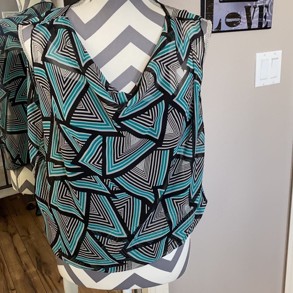 Black, green, white woman’s tank style shirt. Loose fitting too w/ fitted waist